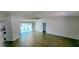 Expansive living room with modern flooring, bright lighting, and seamless flow to the kitchen at 8771 Sw 115Th St, Ocala, FL 34481