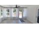 Sunroom featuring large windows with sheer curtains and door to yard, creating a bright and airy space at 8771 Sw 115Th St, Ocala, FL 34481