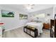 Cozy bedroom with wood-look floors, a ceiling fan, and plenty of natural light at 8841 Sw 91St St # A, Ocala, FL 34481