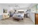 Comfortable bedroom with a queen-sized bed, wood-look floors, and neutral decor at 8841 Sw 91St St # A, Ocala, FL 34481
