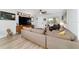 Open-concept living area featuring a comfortable sectional sofa, hardwood flooring, and plenty of natural light at 8841 Sw 91St St # A, Ocala, FL 34481