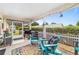 Cozy screened-in patio with comfortable chairs and a barbecue grill, perfect for outdoor living at 8841 Sw 91St St # A, Ocala, FL 34481