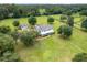 Expansive property featuring a traditional home with a wraparound porch and lush green acreage at 9095 Sw 9Th Ter, Ocala, FL 34476