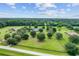 Scenic aerial shot of countryside homes with expansive lawns, framed by mature trees and fencing at 9095 Sw 9Th Ter, Ocala, FL 34476