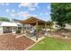 Lovely backyard featuring outdoor seating and dining, pool, lounging area, pond, bridge and mature trees at 9095 Sw 9Th Ter, Ocala, FL 34476