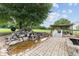 Landscaped backyard with pond, stream and bridge leading to pergola covered dining and seating areas at 9095 Sw 9Th Ter, Ocala, FL 34476