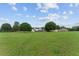 Large backyard and big house with screened in porch, all under a sunny blue sky at 9095 Sw 9Th Ter, Ocala, FL 34476