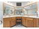 Spacious main bathroom featuring dual sinks and a large mirror at 9095 Sw 9Th Ter, Ocala, FL 34476