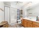 Neutral bathroom featuring a tub, shower, and wooden vanity at 9095 Sw 9Th Ter, Ocala, FL 34476