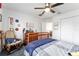 Spacious bedroom featuring carpeted flooring, ceiling fan, and rocking chair at 9095 Sw 9Th Ter, Ocala, FL 34476