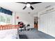 Carpeted bedroom with a ceiling fan, computer setup, and natural light at 9095 Sw 9Th Ter, Ocala, FL 34476