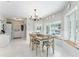 Bright dining area with wood table, views of the pool, white floors, and decorative wainscoting at 9095 Sw 9Th Ter, Ocala, FL 34476