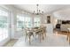 Bright dining area featuring a wood table and chairs next to large window overlooking the pool at 9095 Sw 9Th Ter, Ocala, FL 34476