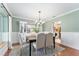 Bright dining room with light green walls, white trim, and stylish chandelier at 9095 Sw 9Th Ter, Ocala, FL 34476