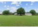 Sprawling, well-maintained lawn with mature trees and a view of the charming home and garage at 9095 Sw 9Th Ter, Ocala, FL 34476