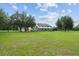 Spacious country home with a large front yard, wraparound porch, and attached garage at 9095 Sw 9Th Ter, Ocala, FL 34476