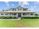 Inviting two-story home with a covered porch, manicured landscaping and a walkway to the front door at 9095 Sw 9Th Ter, Ocala, FL 34476