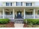 Inviting front porch with rocking chairs and meticulously landscaped surroundings at 9095 Sw 9Th Ter, Ocala, FL 34476