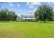 Lovely home with a wraparound porch surrounded by a well-maintained lawn and mature trees at 9095 Sw 9Th Ter, Ocala, FL 34476