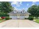 Detached two-car garage with matching architectural details and ample parking space at 9095 Sw 9Th Ter, Ocala, FL 34476