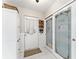 Hallway with white pantry doors, storage cabinet, and a doorway to outside at 9095 Sw 9Th Ter, Ocala, FL 34476