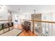 Upstairs hallway with wooden flooring and stone accent wall at 9095 Sw 9Th Ter, Ocala, FL 34476