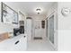 Hallway with white wainscoting, decorative glass pantry doors, and access to the laundry room at 9095 Sw 9Th Ter, Ocala, FL 34476