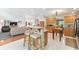 Open kitchen with stone breakfast bar, wood cabinets, and stainless steel appliances overlooks the living area at 9095 Sw 9Th Ter, Ocala, FL 34476