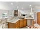 Open kitchen showcasing wood cabinets, marble countertops, and an adjacent living space at 9095 Sw 9Th Ter, Ocala, FL 34476
