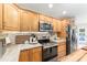 Well-equipped kitchen features stainless appliances, marble counters, and wood cabinets at 9095 Sw 9Th Ter, Ocala, FL 34476