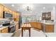 Gourmet kitchen boasting wood cabinetry, stainless appliances, marble counters and eat in area at 9095 Sw 9Th Ter, Ocala, FL 34476