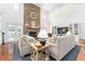 Bright living room featuring a stone fireplace, hardwood floors, and comfortable seating at 9095 Sw 9Th Ter, Ocala, FL 34476