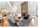Open-concept living room showcasing a stone fireplace, hardwood floors, and access to the kitchen at 9095 Sw 9Th Ter, Ocala, FL 34476