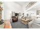 Bright living room with a soaring ceiling, stone fireplace, and cozy seating arrangement at 9095 Sw 9Th Ter, Ocala, FL 34476