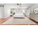 Serene main bedroom with hardwood floors, white linens, and natural light at 9095 Sw 9Th Ter, Ocala, FL 34476