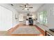 Well-lit home office with a large window, ceiling fan, and hardwood floors at 9095 Sw 9Th Ter, Ocala, FL 34476