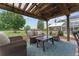 Cozy outdoor living area featuring comfortable seating, a pergola, and a view of the expansive, green yard at 9095 Sw 9Th Ter, Ocala, FL 34476