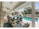 Covered patio area overlooking a swimming pool and backyard at 9095 Sw 9Th Ter, Ocala, FL 34476