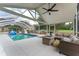 Screened-in patio with swimming pool, seating, and fire pit at 9095 Sw 9Th Ter, Ocala, FL 34476