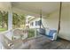 Covered porch with comfortable seating, perfect for relaxing outdoors at 9095 Sw 9Th Ter, Ocala, FL 34476
