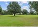 Lush front yard featuring mature trees with Spanish moss enhancing the landscape of the property at 9095 Sw 9Th Ter, Ocala, FL 34476