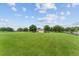 View of a large grassy property with a house, mature trees, and fence lines at 9095 Sw 9Th Ter, Ocala, FL 34476