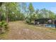 Expansive backyard featuring a screened-in pool, lush trees, and plenty of room for outdoor activities at 9180 Sw 202Nd Avenue Rd, Dunnellon, FL 34431