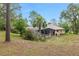 Spacious backyard view with a pool and surrounding trees, offering a private outdoor retreat at 9180 Sw 202Nd Avenue Rd, Dunnellon, FL 34431