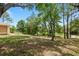 Spacious backyard with mature trees provides privacy and shade, perfect for outdoor entertaining and relaxation at 9180 Sw 202Nd Avenue Rd, Dunnellon, FL 34431