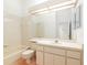 Bright bathroom features a tub, neutral tile, and a large mirror with ample counter space at 9180 Sw 202Nd Avenue Rd, Dunnellon, FL 34431