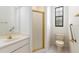 Bathroom featuring glass shower, toilet, and vanity with ample lighting at 9180 Sw 202Nd Avenue Rd, Dunnellon, FL 34431