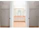 En-suite bathroom featuring double sinks, a large mirror, and access to a shower at 9180 Sw 202Nd Avenue Rd, Dunnellon, FL 34431