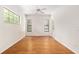 Bright, spacious bedroom with wood floors, large windows, and a ceiling fan at 9180 Sw 202Nd Avenue Rd, Dunnellon, FL 34431