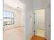 Inviting bedroom with large window and a glimpse of an attached laundry room at 9180 Sw 202Nd Avenue Rd, Dunnellon, FL 34431